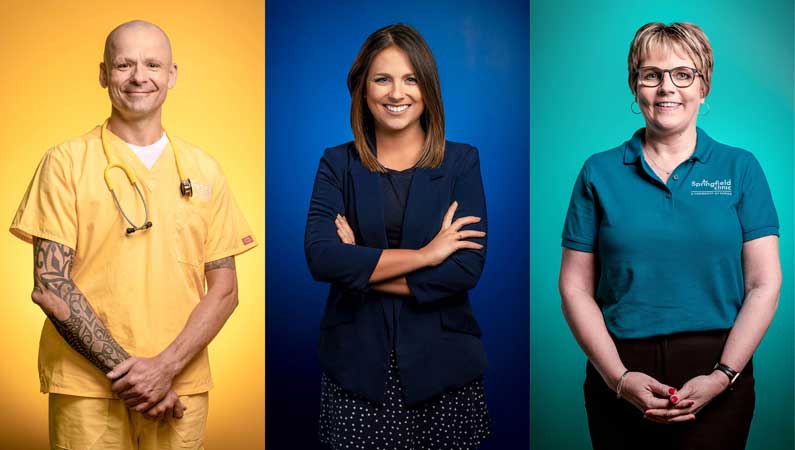Three people dressed in yellow, blue and green posing in front of coordinated color backgrounds